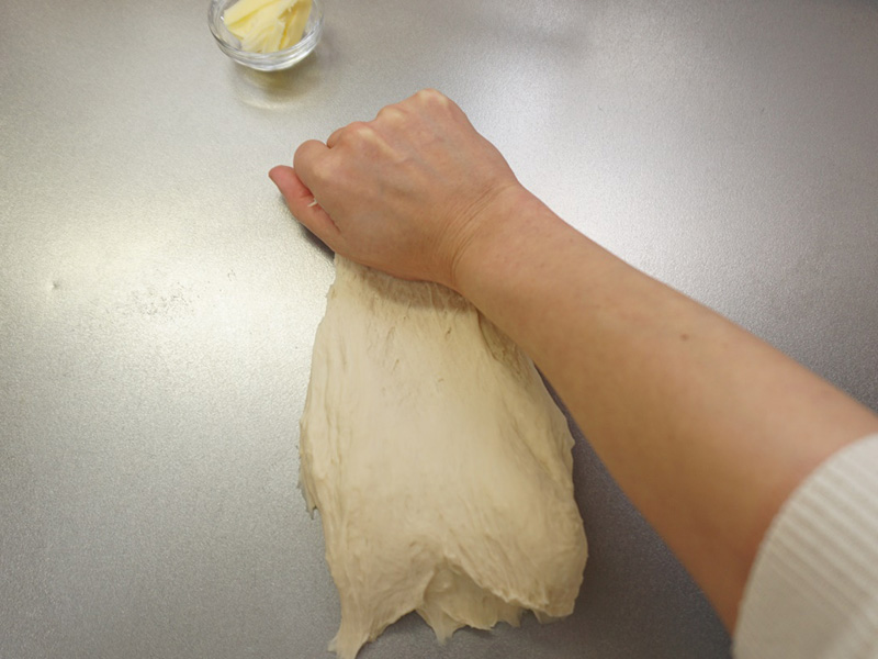 手のひらを使って、手前から奥に向かって台にこすり付けるように捏ねます。手前の生地がだんだん奥に送られていきます。